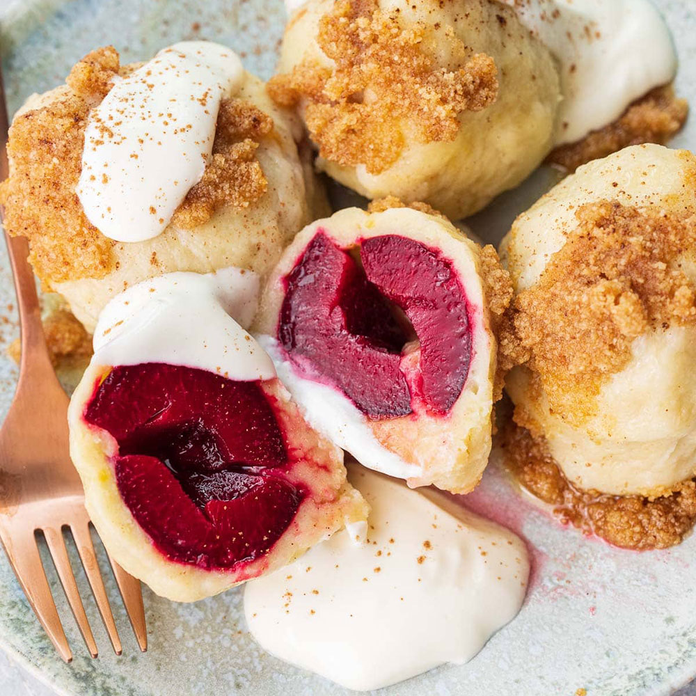 Knedle (Crumbed Mango dumpling with sour cream  and cherry sauce)